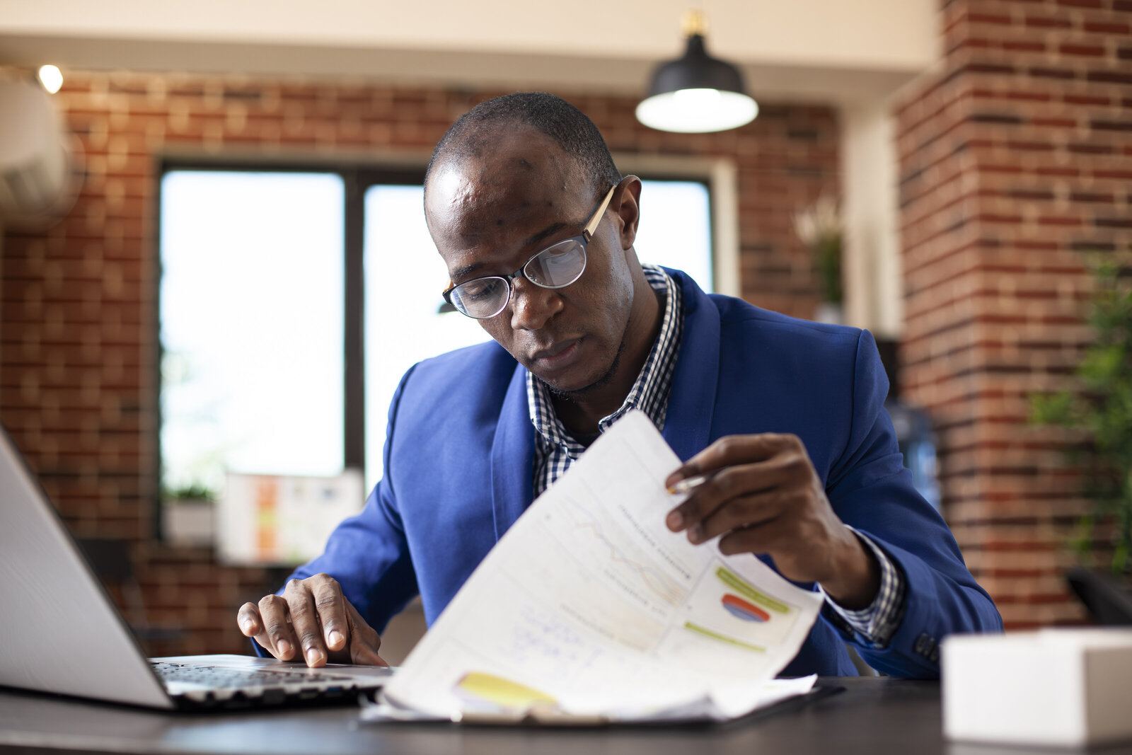 Business owner reviewing documents at his desk